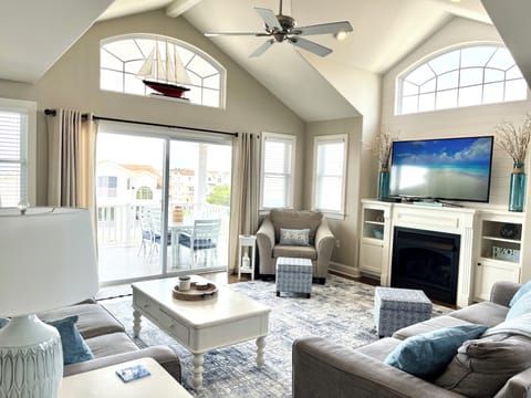 Spacious 3rd floor living area with deck access including dining & seating areas