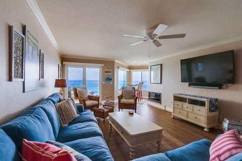 The living room opens to the beach just beyond the windows.