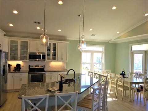 Kitchen with large island with 8 seats.  Another 8 seats at dining table