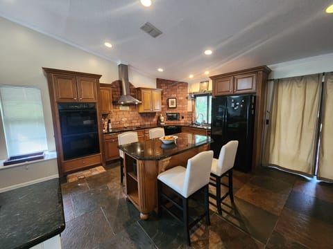 Gourmet kitchen with granite counter tops and large island