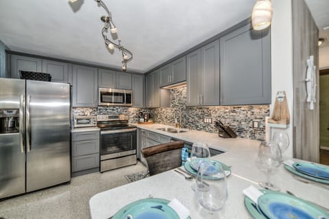 Full-size kitchen with dishwasher, stove, microwave, coffee maker, toaster, blender, spices, Knife Set, 14 piece cook set, mixing bowls, baking pans, plenty of dish-ware, cooking utensils and plasticware. 