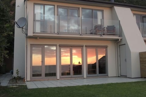 Sunset reflected in beachside bifold doors
