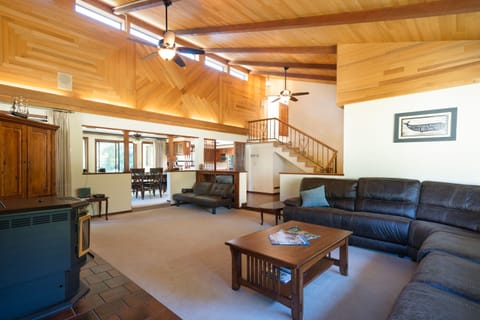 Very spacious living room with custom wood,  opening into the dining room.