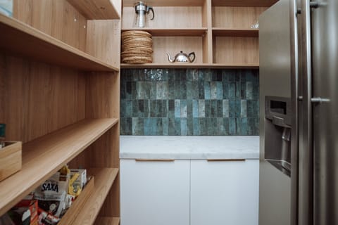 Walk in pantry and double door fridge. 