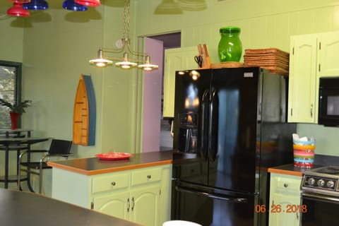 Three door frig and entrance to pink bedroom.  Complete kitchen in this space.