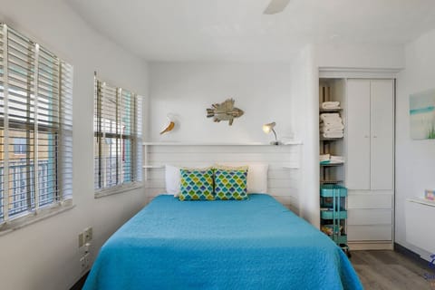Comfortable Queen Bed with Bright Natural Light, Coastal Bedding & Convenient Storage