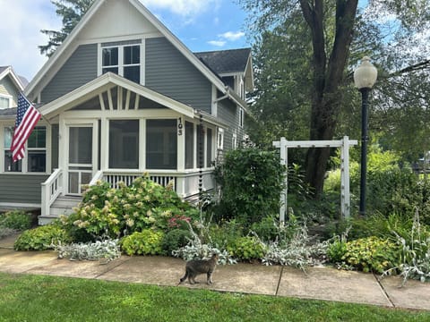 Take a stroll along the perennial filled yard and stone path along the side.