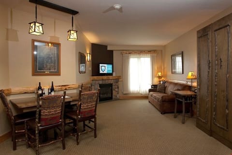 After a long day in the mountains, relax in front of the grand stone fireplace to warm up