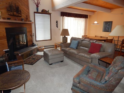 Sink into plush leather seating by your crackling fireplace, where warm wood beams and mountain charm create the perfect retreat.
