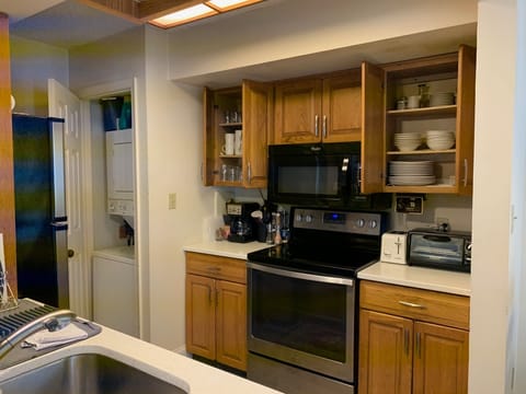 fully stocked kitchen with washer, dryer, electric convection oven, dishwasher, 