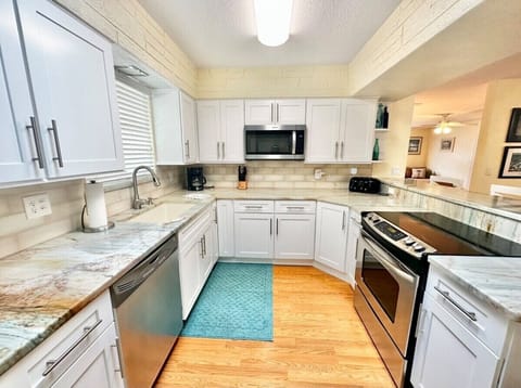The kitchen has all new appliances, including a coffee maker and dishwasher.