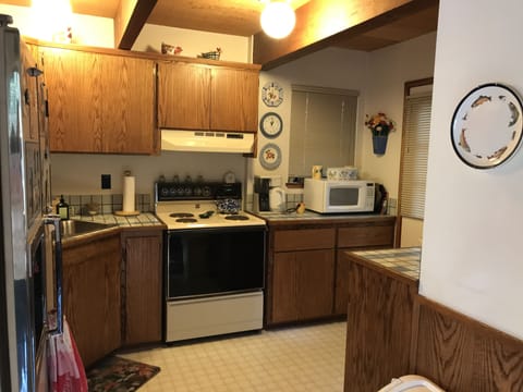 With refrigerator, coffee maker, microwave, toaster, dishes, and cookware 