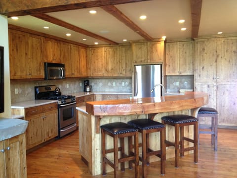 fully furnished gourmet kitchen off living room and dining room