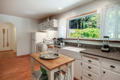 A farmhouse sink and new countertops grace the kitchen.