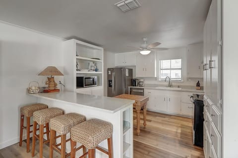 1st Floor - A stylish kitchen island anchors the space, blending function with coastal charm