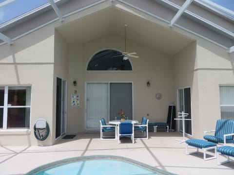 Shaded area by pool with outdoor dining area