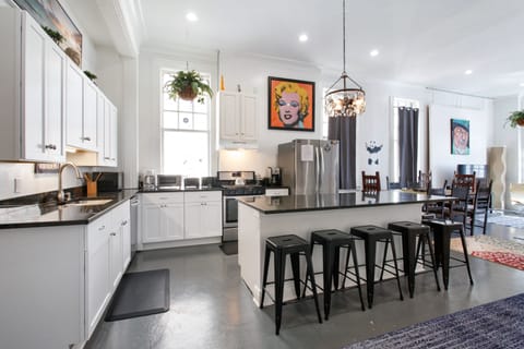 Bright, spacious kitchen with 6-seat island is open to dining and  living areas.