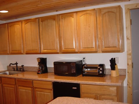 Lower level kitchenette; refrig., coffeemaker, toaster oven, dishes, utensils