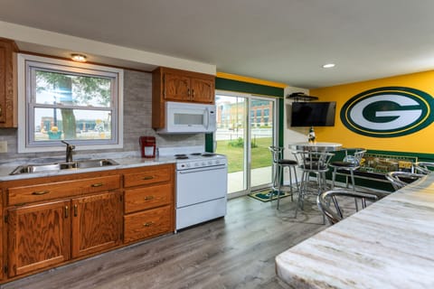Kitchen with entrance to patio and view of Lambeau