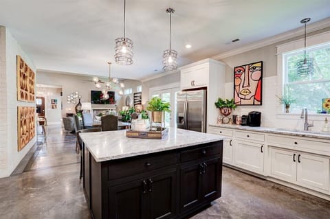 Spacious, fully stocked kitchen features high end All Clad cookware. 