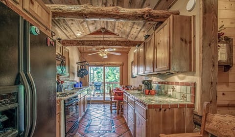 View of Kitchen fully stocked with cooking utensils, dinnerware, and cooking pots & pans