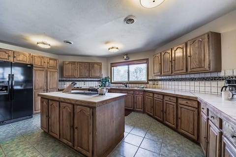 The kitchen features ample counter top space and an island
