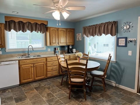 Antique kitchen table with 5 chairs, additional chairs and table in basement