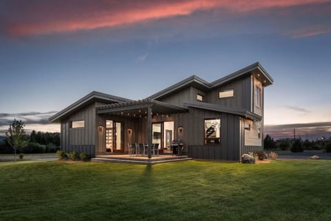 A view of the home and pergola from the yard.