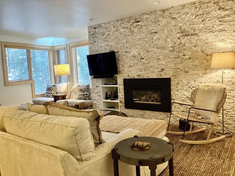 Relax in your elegant living room featuring a cozy fireplace and plush seating perfect for unwinding after exploring.