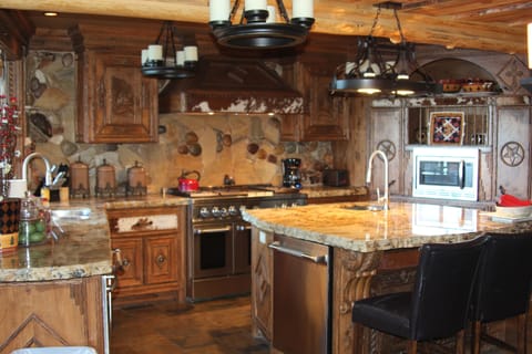 Chef's Cabin Kitchen with custom carved cabinets, granite, and room to cook