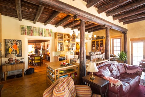 Great room & kitchen - The red sofa faces a fireplace and pulls out to a bed