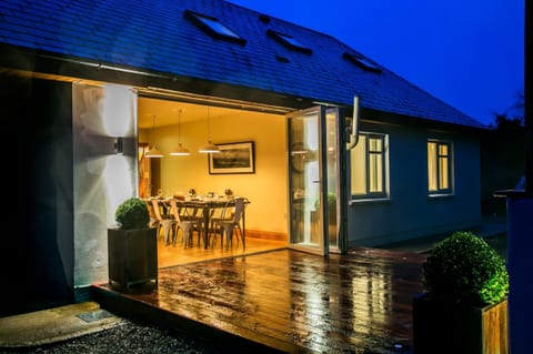 Large dining area opens to covered outdoor seating with fire pit