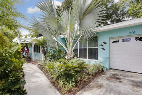 Front view, tropical paradise with lush landscaping, hassle free yard