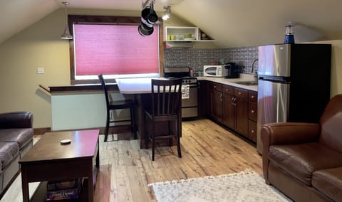 Kitchen with fridge, microwave, stove, and Keurig coffee.