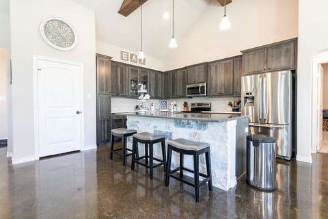 Full kitchen featuring a refrigerator, microwave, stove/oven, and dishwasher