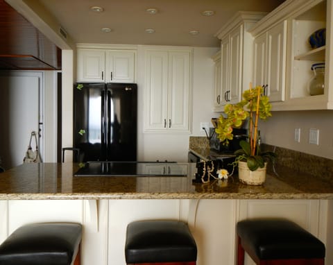 Remodeled kitchen with new cabinets, granite, appliances, and flooring.