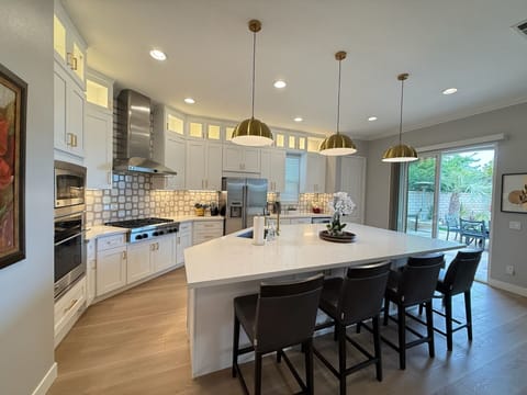 Beautifully updated kitchen features a stunning oversized island.