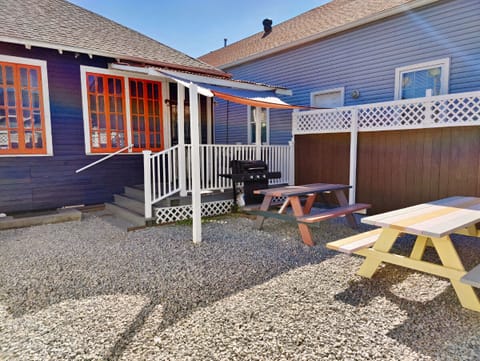 Rear fenced in private courtyard. Shaded propane grill, roofed porch w swinging bench. Off street parking not pictured.
