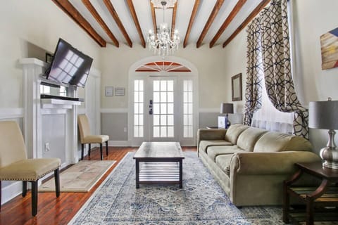 Spacious living room with sleeper sofa, smart TV, and exposed beams