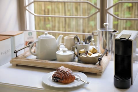 Adjacent to the kitchen is a separate tea/coffee station with plenty of storage