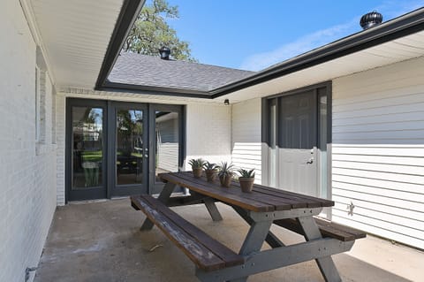 Back porch picnic table seats 8. Additional folding table accessible inside.