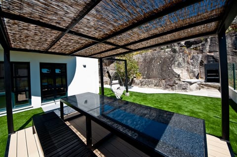 Inviting dining and barbecue area with garden and sea views