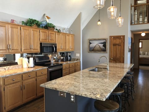 Spacious kitchen with 12’ granite island for family meals.