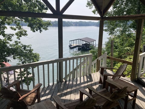 Gazebo with Adirondack rockers and long padded benches by the lake.