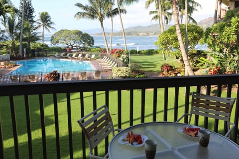 View of ocean, pool and landscaped grounds from lanai