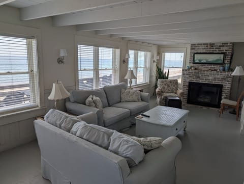 Living room with wraparound ocean views, bar, gas fireplace