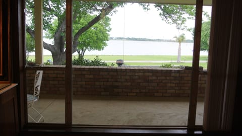 Second bedroom view of the water, and palm trees swaying in the breeze.