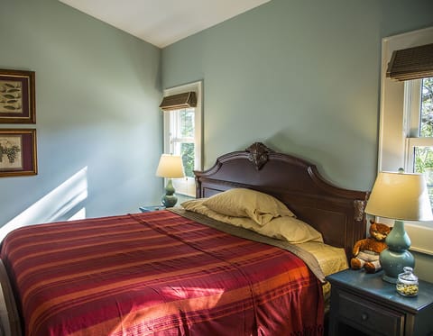 His and hers nightstands, lamps and windows.