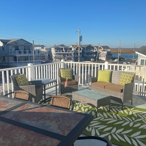 Living room has large deck with views of the bay and peek view of the ocean.
