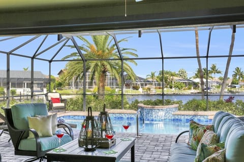 The oversized pool deck sits in nearly 1/2 an acre of land and has a covered outdoor living with cable TV